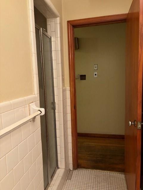 1902 Godby Rd, Atlanta, GA 30349 - bathroom featuring tile walls, tile patterned flooring, and a shower with shower door