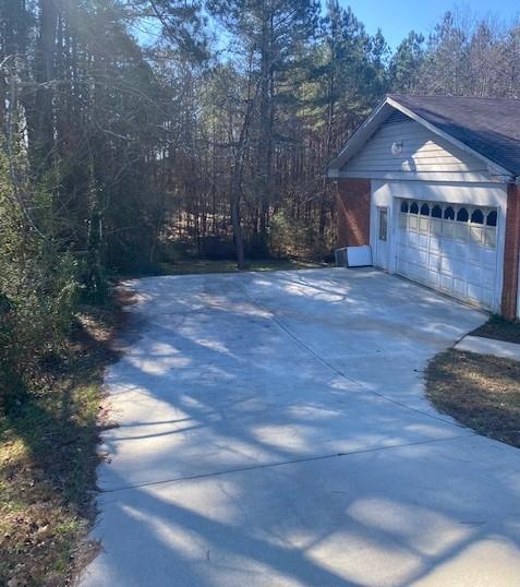 1902 Godby Rd, Atlanta, GA 30349 - view of side of home featuring a garage
