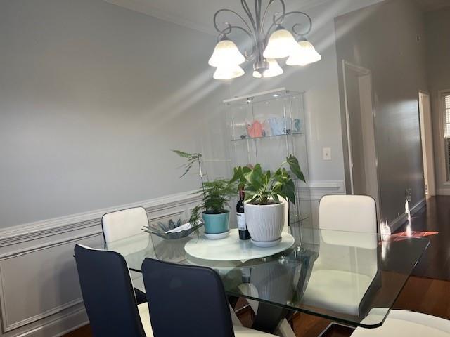 dining area featuring dark hardwood / wood-style flooring and a notable chandelier