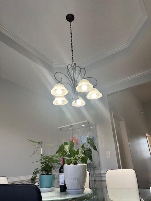 room details with ornamental molding and a chandelier