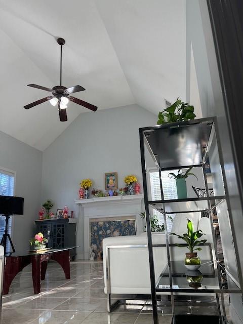 interior space featuring lofted ceiling and ceiling fan