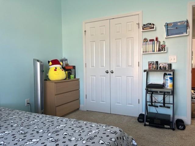 bedroom with carpet floors and a closet