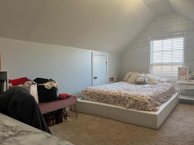 bedroom with vaulted ceiling and light carpet