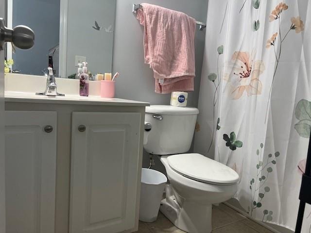 bathroom featuring a shower with shower curtain, vanity, toilet, and tile patterned flooring