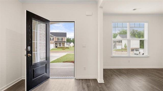 entrance foyer with ornamental molding and dark wood-type flooring