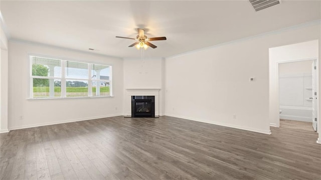 unfurnished living room featuring dark hardwood / wood-style flooring, ceiling fan, and ornamental molding