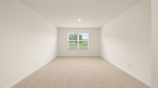 spare room with light colored carpet