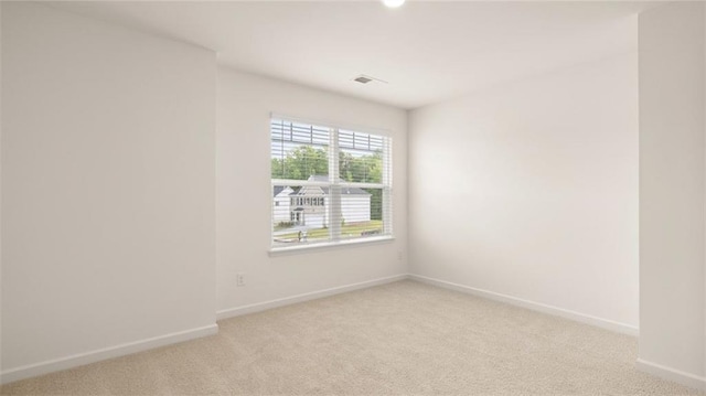 unfurnished room with light colored carpet