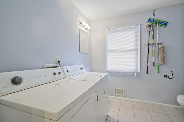 washroom featuring light tile patterned floors and washer and dryer