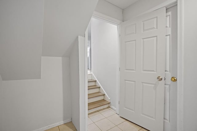 stairway with tile patterned floors