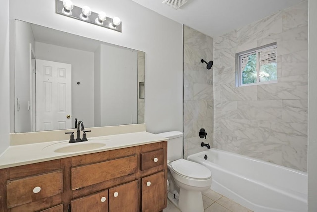 full bathroom featuring tile patterned floors, tiled shower / bath combo, vanity, and toilet