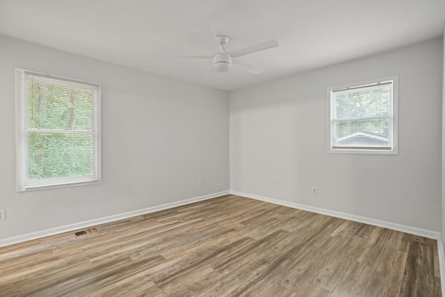 spare room featuring hardwood / wood-style floors and ceiling fan