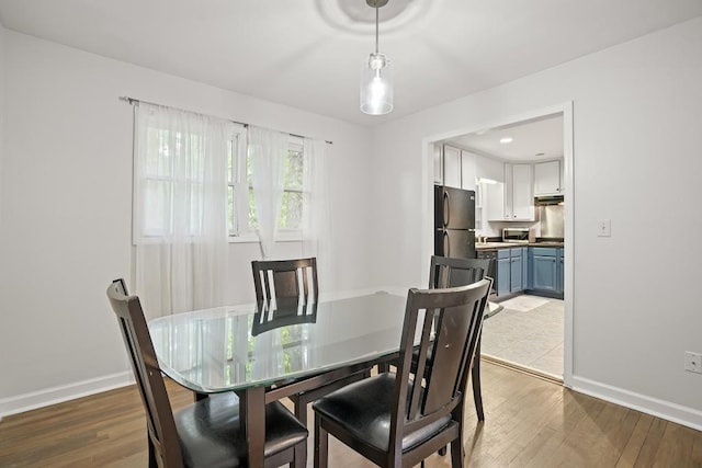 dining space with hardwood / wood-style floors