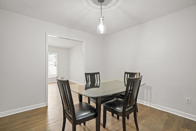 dining space with dark wood-type flooring