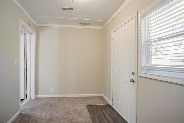 interior space featuring visible vents, crown molding, and baseboards