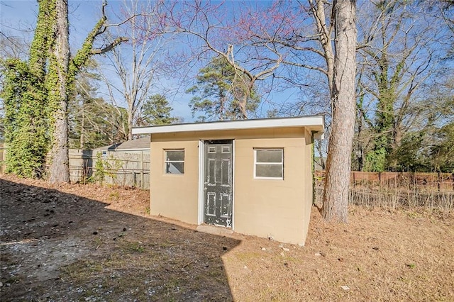 view of shed featuring fence