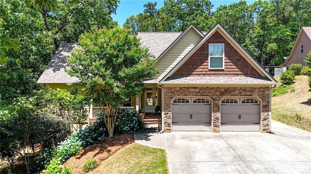 34 Laurel Way NE, White, GA 30184 - view of front of house featuring concrete driveway, stone siding, a garage, and roof with shingles