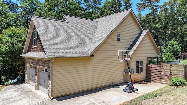 34 Laurel Way NE, White, GA 30184 - view of side of home with roof with shingles, a garage, driveway, and a patio area