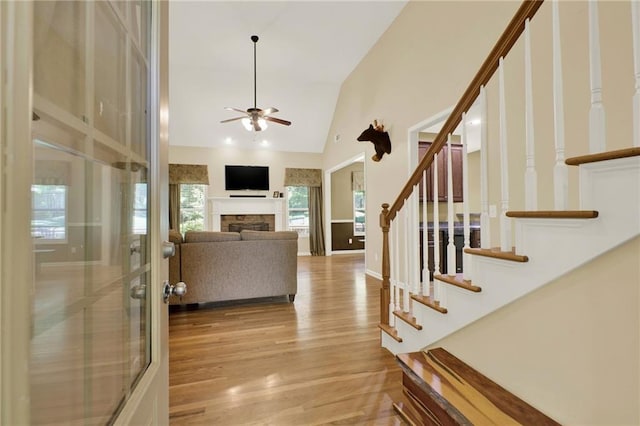 34 Laurel Way NE, White, GA 30184 - living area featuring stairs, a ceiling fan, wood finished floors, high vaulted ceiling, and a stone fireplace