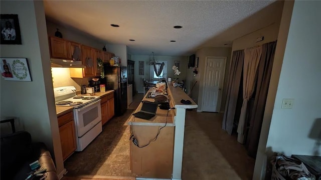 kitchen featuring black refrigerator, a textured ceiling, and white electric range oven