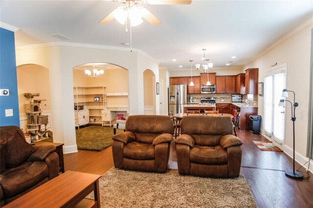 6892 Big Sky Dr, Flowery Branch, GA 30542 - living area featuring arched walkways, dark wood-style flooring, a chandelier, ceiling fan, and crown molding
