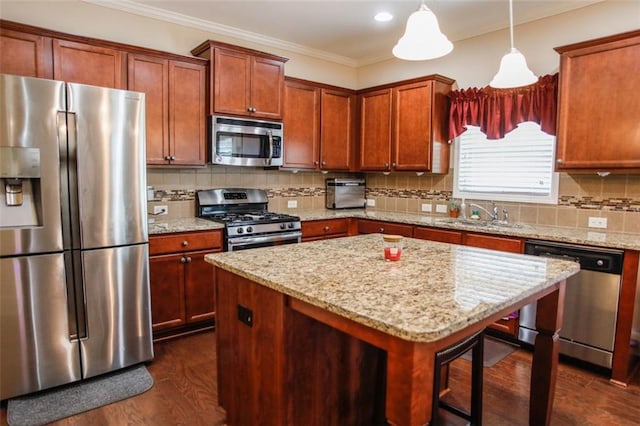 6892 Big Sky Dr, Flowery Branch, GA 30542 - kitchen with stainless steel appliances, a sink, light stone countertops, dark wood-type flooring, and ornamental molding
