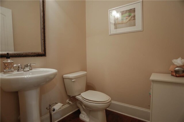 6892 Big Sky Dr, Flowery Branch, GA 30542 - bathroom with baseboards, toilet, and a sink