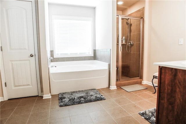 6892 Big Sky Dr, Flowery Branch, GA 30542 - bathroom with tile patterned flooring, a shower stall, a bath, vanity, and baseboards