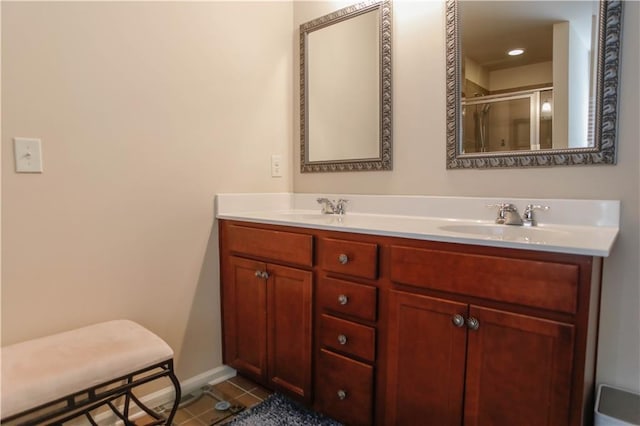 6892 Big Sky Dr, Flowery Branch, GA 30542 - bathroom with double vanity, a shower stall, baseboards, and tile patterned flooring