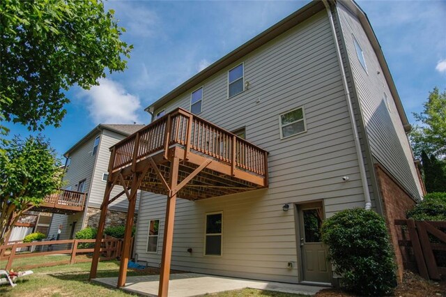 6892 Big Sky Dr, Flowery Branch, GA 30542 - rear view of house with a deck and a patio area