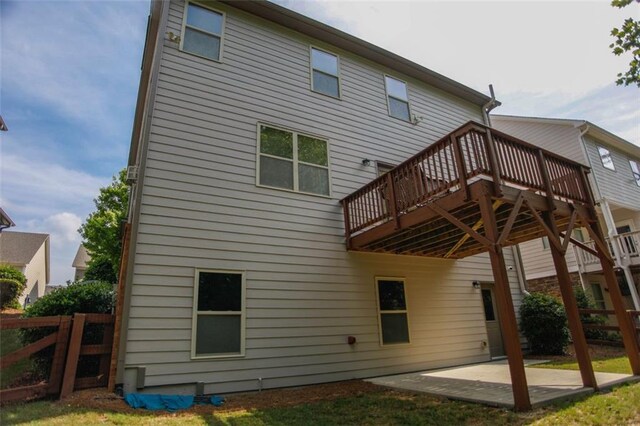 6892 Big Sky Dr, Flowery Branch, GA 30542 - back of property with fence, a patio, and a wooden deck