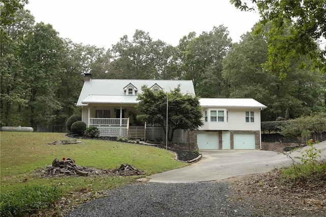 view of front facade with a garage, a porch, and a front lawn