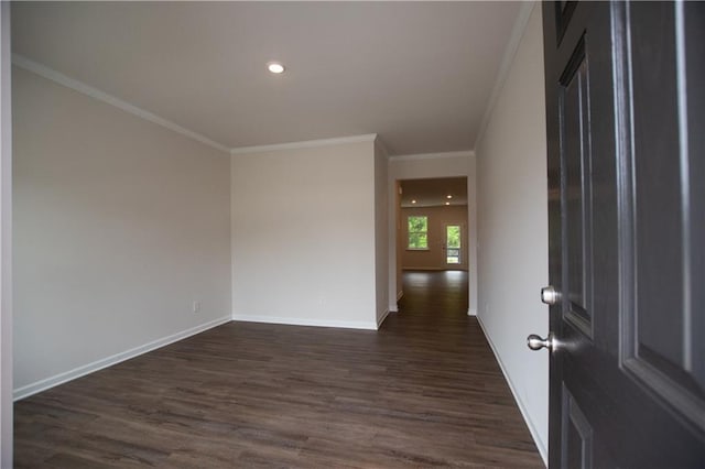 empty room featuring dark hardwood / wood-style flooring and ornamental molding