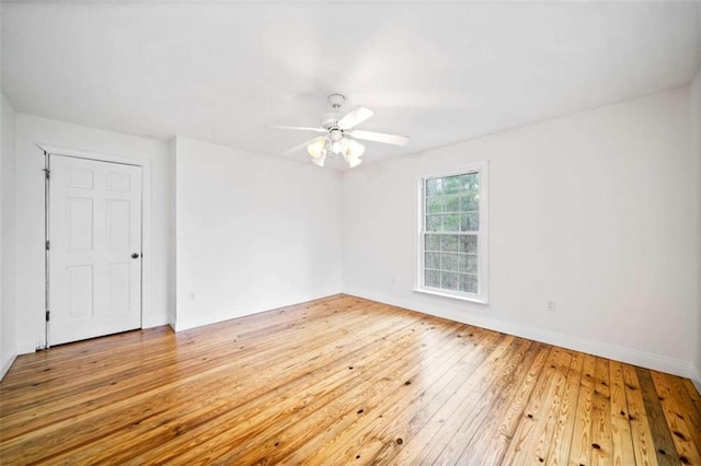 empty room with ceiling fan and light wood-type flooring