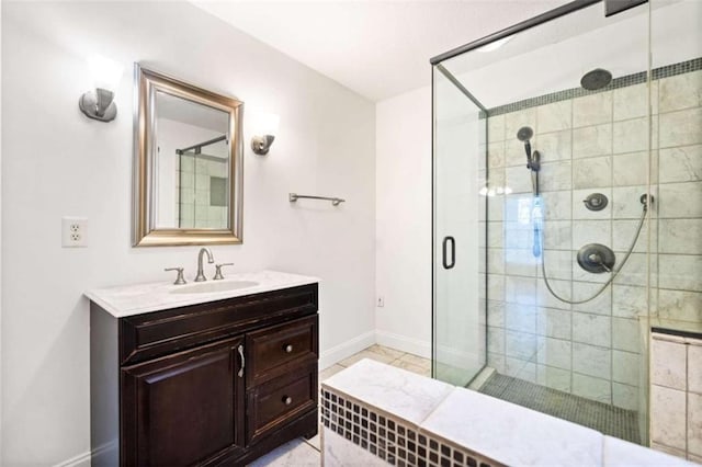 bathroom featuring vanity and a shower with shower door