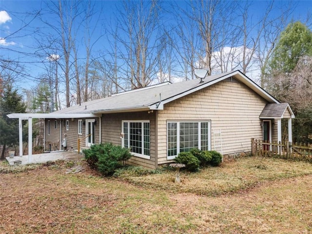 view of side of home featuring a lawn