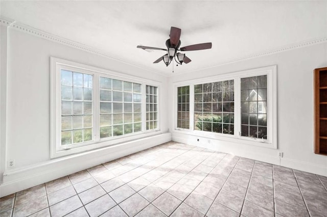 unfurnished sunroom featuring ceiling fan