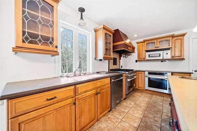 kitchen featuring light tile patterned flooring, sink, custom exhaust hood, decorative light fixtures, and appliances with stainless steel finishes