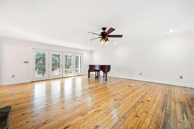 living room with light hardwood / wood-style flooring and ceiling fan