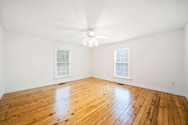 unfurnished room featuring ceiling fan, light hardwood / wood-style flooring, and a wealth of natural light