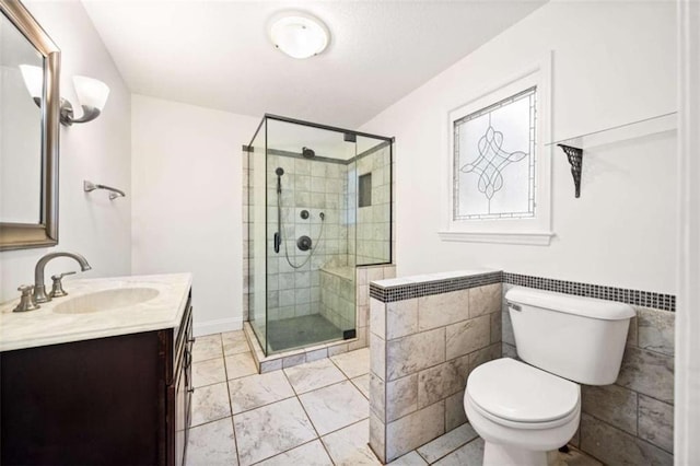 bathroom featuring vanity, tile walls, an enclosed shower, and toilet