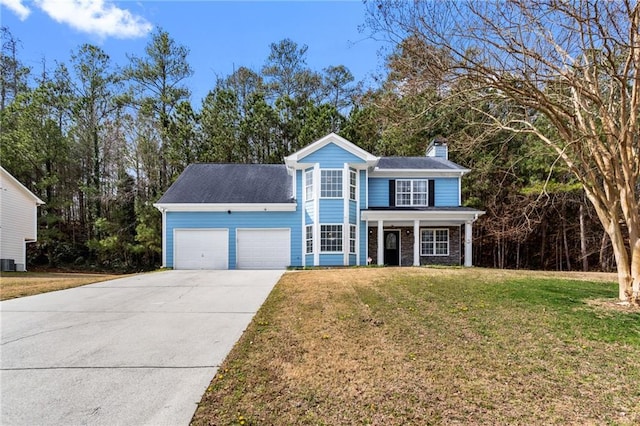 traditional home featuring a chimney, a porch, concrete driveway, a garage, and a front lawn