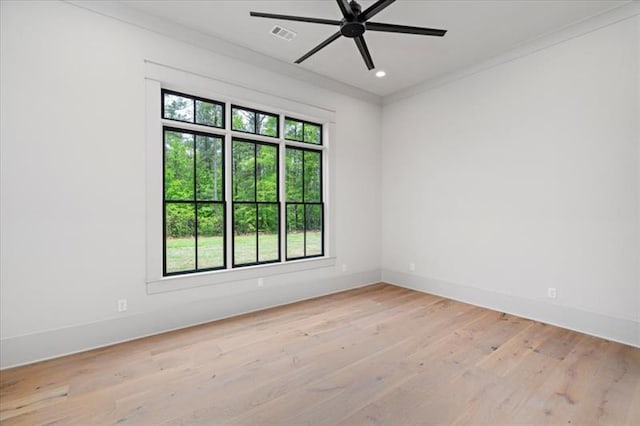 unfurnished room featuring light wood-type flooring, ceiling fan, and crown molding