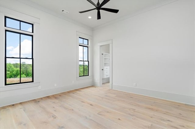 unfurnished room featuring ceiling fan, crown molding, and light hardwood / wood-style flooring