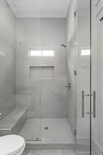 bathroom with toilet and walk in shower