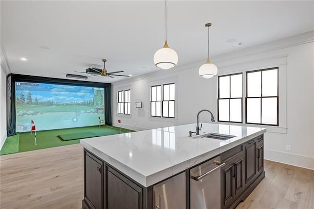 kitchen featuring dark brown cabinetry, sink, golf simulator, and plenty of natural light