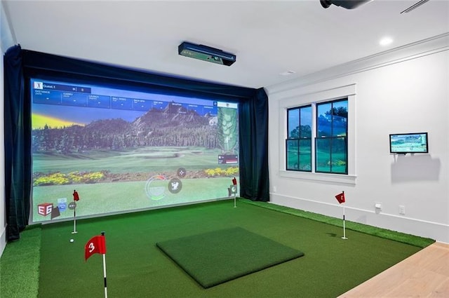 rec room with crown molding and golf simulator