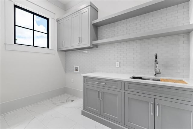 laundry area featuring cabinets, washer hookup, and sink