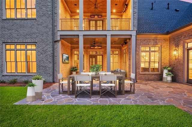 view of patio featuring ceiling fan and a balcony