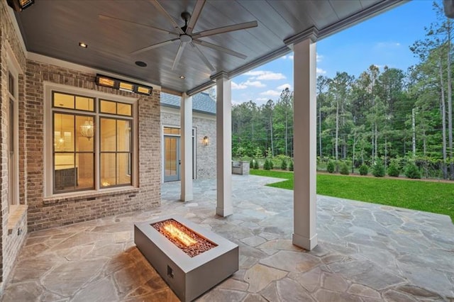 view of patio with an outdoor fire pit and ceiling fan